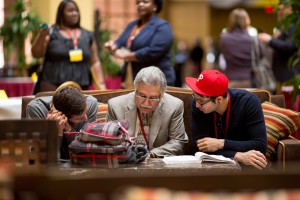 Two students with a professor at the 2013 Field of Dreams conference.